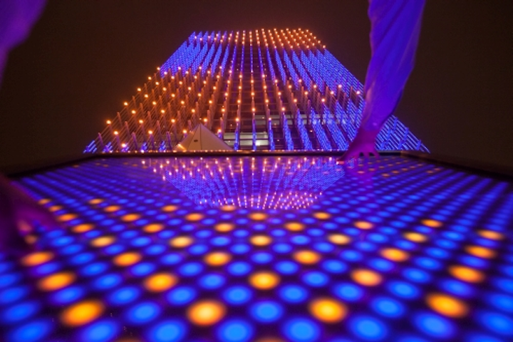 The 3D solid-state lighting (SSL) implementation is combined with an interactive control pedestal at ground level that allows the public to control the lighting.