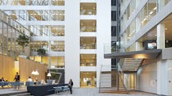 FIG. 1. The newly-built Edge building in Amsterdam is known for its IoT backbone and the ubiquitous deployment of Power over Ethernet as a backbone that enables advanced applications such as space optimization, but building retrofits need the flexibility of a wireless network and a standard intra-luminaire bus can enable flexible choices in inter-luminaire connectivity. (Photo credit: Image courtesy of Deloitte Group, photographer Ronald Tilleman; http://tilleman.nl.) FIG. 1. The newly-built Edge building in Amsterdam is known for its IoT backbone and the ubiquitous deployment of Power over Ethernet as a backbone that enables advanced applications such as space optimization, but building retrofits need the flexibility of a wireless network and a standard intra-luminaire bus can enable flexible choices in inter-luminaire connectivity. (Photo credit: Image courtesy of Deloitte Group, photographer Ronald Tilleman; http://tilleman.nl.)