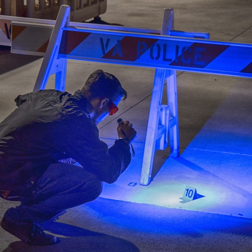 Forensic specialist uses a FoxFury HammerHead Forensic Light System to examine evidence in the field.