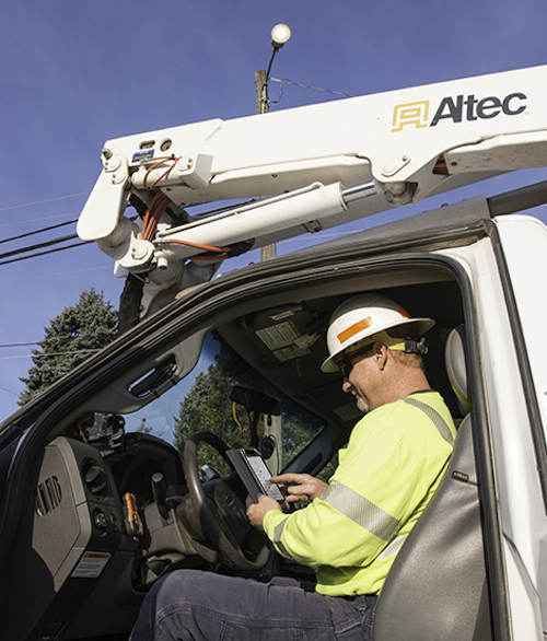 A Pend Oreille lineman uses the ConnectLED app on an Android tablet to control an AreaMax (above)