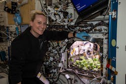 Astronaut Kate Rubins smiles with radishes under the LED grow lights on the International Space Station last week week, prior to collecting leaf samples. (Photo credit: Image courtesy of NASA Johnson/Flickr. Used under CC BY-NC-ND 2.0; https://creativecommons.org/licenses/by-nc-nd/2.0/)