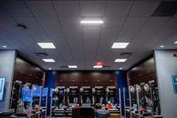 The National Football League&apos;s Miami Dolphins are running an innovative air game inside the locker room, where about 40 Healthe ceiling troffers, such as the one in the middle foreground of the ceiling in this photo, are equipped with a filtration system and Crystal IS UV-C LEDs to attack the SARS-CoV-2 virus. (Photo credit: Image courtesy of Healthe Inc.)