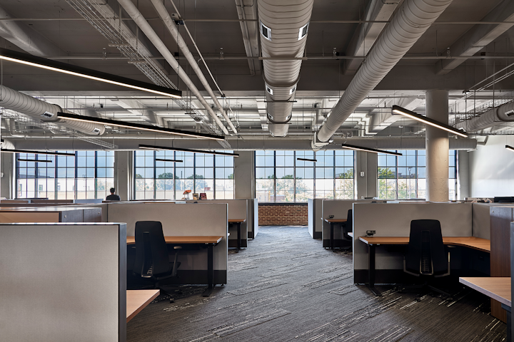 Memphis architectural design firm LRK worked with A-Light luminaires to enhance the natural light coming into the new Orion Federal Credit Union headquarters in a historic building that incorporates the original industrial-looking concrete and exposed ductwork alongside modern aesthetics and layered lighting. (Photo credits: Images by McGinn Photography for A-Light.)