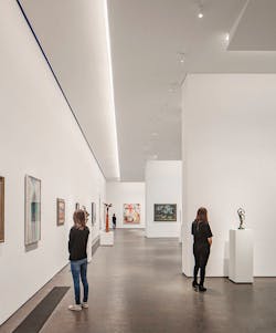 The Museum of Fine Arts, Houston (MFAH) desired diffuse but uniform illumination that could mimic the daylighting used in other areas of the building. Two-channel light engines produce 3000K- and 5000K-CCT light that mixes in the QuarkStar Edge-X light guide designed into a luminaire that is hidden from the visitor&rsquo;s eye in gallery ceiling coves. (Photo credit: Image by Richard Barnes, courtesy of the Museum of Fine Arts Houston.)