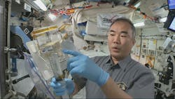 Astronaut Soichi Naguchi injects water into a glass chamber already containing basil seeds. (Photo credit: All images courtesy of JAXA/NASA; https://iss.jaxa.jp/en/kuoa/ssaf/mission-1_results.html#0216.)
