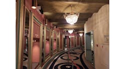 Amsterdam&apos;s Royal Theater Carr&eacute; installed some of the 75 upper-air UV-C disinfection luminaires in this corridor. They are the black-and-white rectangular boxes at the top of the pink wall along the left. (Photo credit: Image courtesy of Signify.)