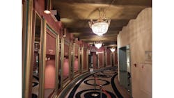 Amsterdam&apos;s Royal Theater Carr&eacute; installed some of the 75 upper-air UV-C disinfection luminaires in this corridor. They are the black-and-white rectangular boxes at the top of the pink wall along the left. (Photo credit: Image courtesy of Signify.)