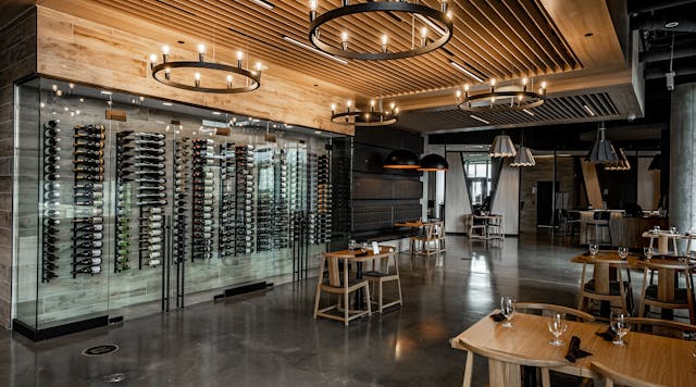 Eureka Lighting Mute fixtures fill volumetric space in a high-ceiling bar area and also deliver a pleasant aural environment. (Photo credit: All images courtesy of Eureka, an Acuity brand.)