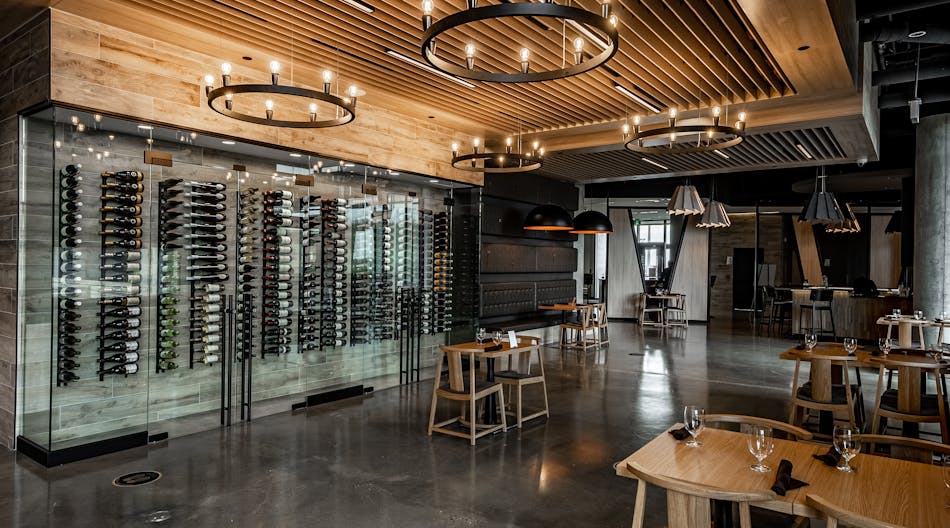 Eureka Lighting Mute fixtures fill volumetric space in a high-ceiling bar area and also deliver a pleasant aural environment. (Photo credit: All images courtesy of Eureka, an Acuity brand.)