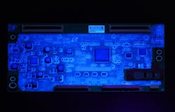 DOWSIL&trade; CC-2588 Conformal Coating is a tough, abrasion-resistant silicone-based material that resists harsh environments and balances sustainability with productivity. DOWSIL&trade; CC-2588 illuminates under UV lamp. (Photo credit: Image courtesy of Dow.)