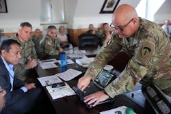 US Army Chief Warrant Officer Andrew Foreman demonstrates Getac hardware working with the Kitefin Li-Fi system at Wiesbaden Army Garrison last August. (Photo credit: Image courtesy of Candy Knight via pureLiFi.)