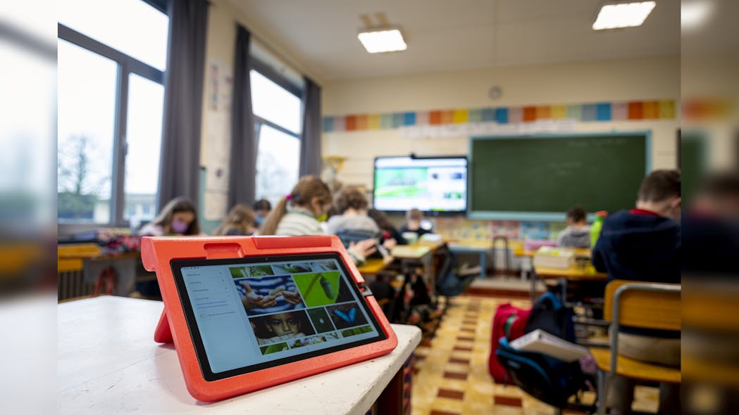 The tablet in the foreground would require a Li-Fi dongle to receive infrared signals traveling from transmitters attached to the ceiling luminaires in this classroom in Flobecq. (Photo credit: Both images courtesy of Signify.)
