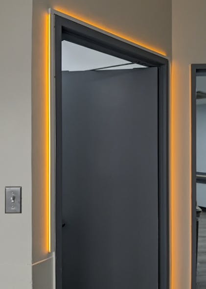 Axis Lighting offers an LED trim light that can wrap doorframes but it must be hardwired.