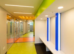 Low-profile linear lights, recessed circular downlights, and slim ceiling mounts provide decorative and navigational illumination in corridors with consideration to children&rsquo;s range of sensory sensitivities.