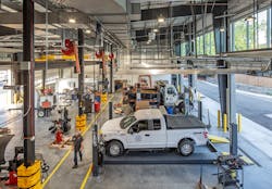 Industrial JEBL High Bays from Lithonia Lighting illuminate the bustling mechanic shop. Industrial JEBL High Bays from Lithonia Lighting illuminate the bustling mechanic shop.
