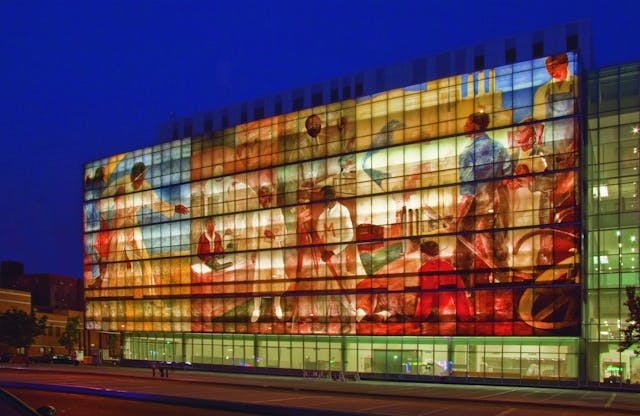 The Harlem Hospital fa&ccedil;ade celebrates the history of Black Americans with a backlit mural.