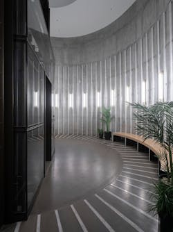 Vertical luminaires echo the circular floor patterns and architecture of the former wash towers.