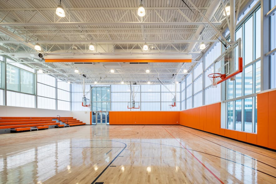 Daylighting and high bays: The gymnasium benefits from natural daylight filtered through frosted acrylic wall coverings and is supplemented by traditional high bays.