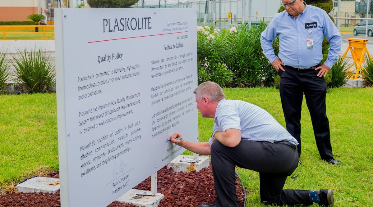 Plaskolite President Ryan Schroeder signing the Plaskolite Quality Policy with Plant Manager Rigoberto Camacho.