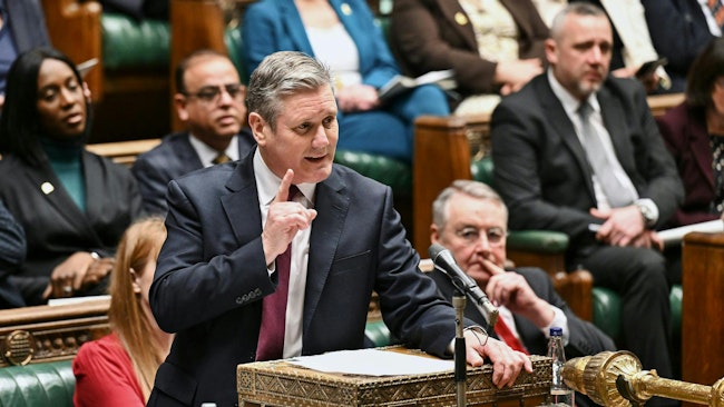 The new Labour government under Prime Minister Keir Starmer must point to headlight glare as one of the key issues to investigate in its transport policy, the RAC says. [Photo of Starmer in action as opposition leader on Feb. 7, 2024 in the U.K. Parliament’s House of Commons.]